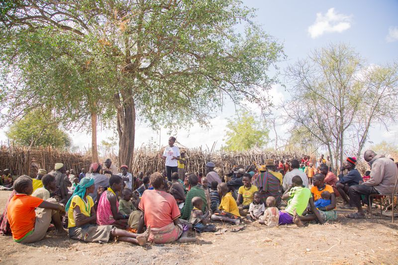 A community meeting under a tree
